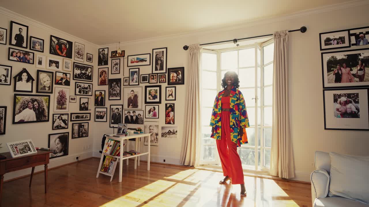 A vibrant room filled with framed photos, featuring a person in colorful attire