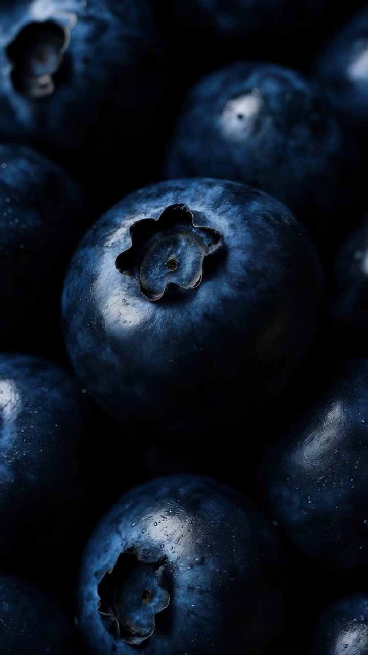 Close-up video shot of fresh blueberries, highlighting their rich blue tones and textures