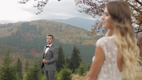 Lovely-caucasian-wedding-couple-newlyweds-family-bride-groom-stay-together-on-mountain-slope-hill