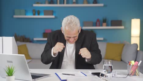 Home-office-worker-man-dances-looking-at-camera.