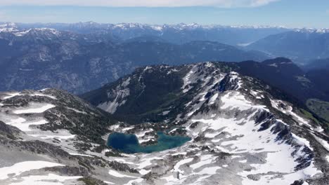 aerial drone panning up to reveal amazing mountain landscape in pacific ranges canada 4k