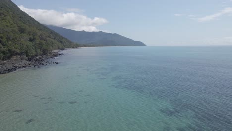 Clear-Blue-Sea-With-Soft-Waves-Splashing-On-Rugged-Shore