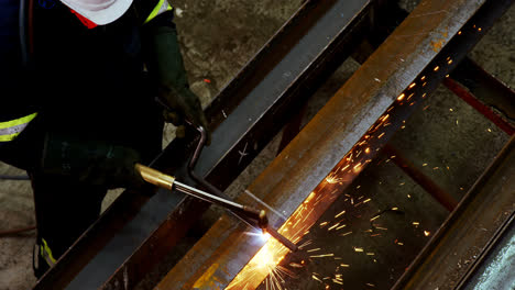 male engineer using welding torch 4k