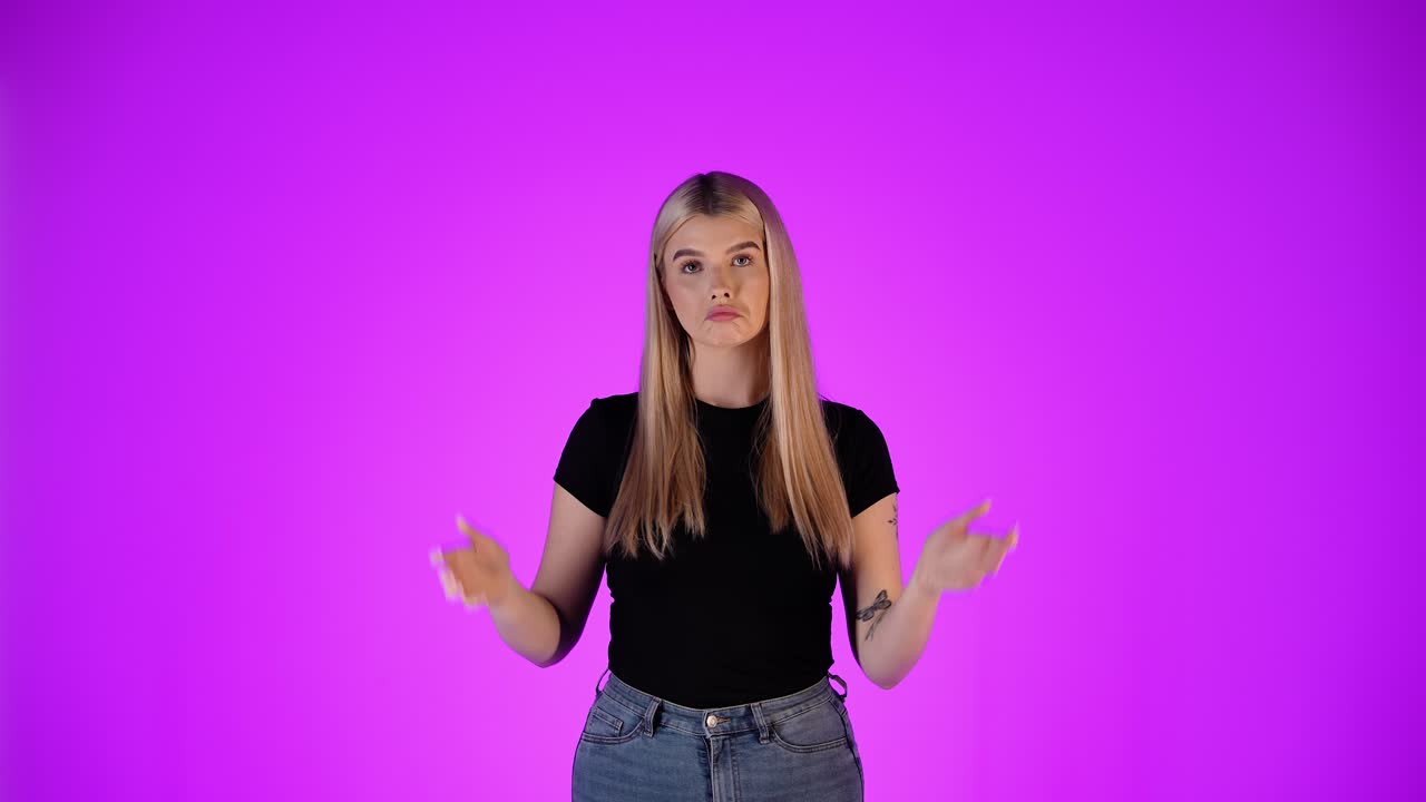 Young Blonde Woman Uncertain, Doubtful Gesture With Hands, Colorful Studio Portrait
