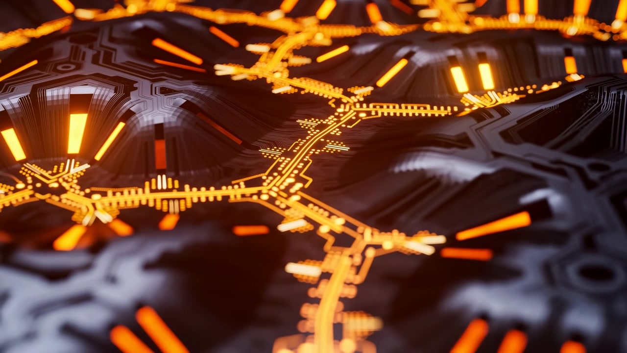 A centered close-up of bright orange circuit paths crossing a dark electronic surface, with soft blur around the foreground and edges under dramatic low light