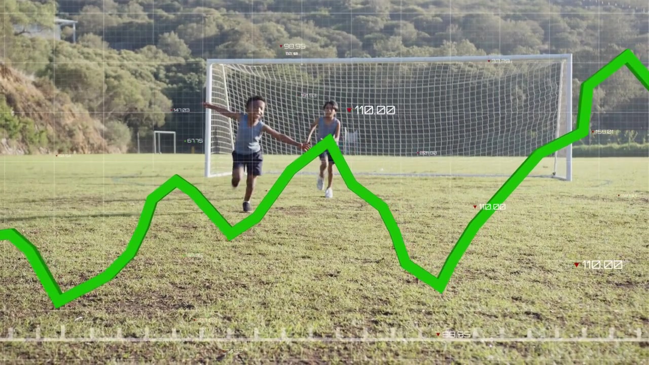 Cam pulling back two boys dribbling to goal keeper diving green graph tracking sports metrics