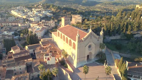 aerial views showcase the stunning church in arta, mallorca, surrounded by lush greenery and picturesque landscapes. perfect setting to appreciate mediterranean culture and architecture.