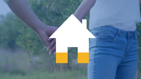 coupel holding hands and house filling yellow