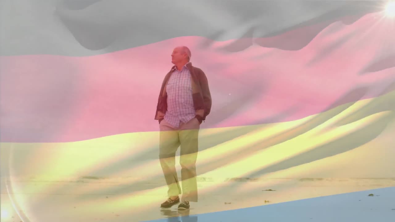 анимация флага германии над старшим кавказским мужчиной с руками в кармане, идущим по пляжу.