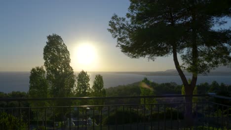 sunset over the ocean from a hilltop balcony