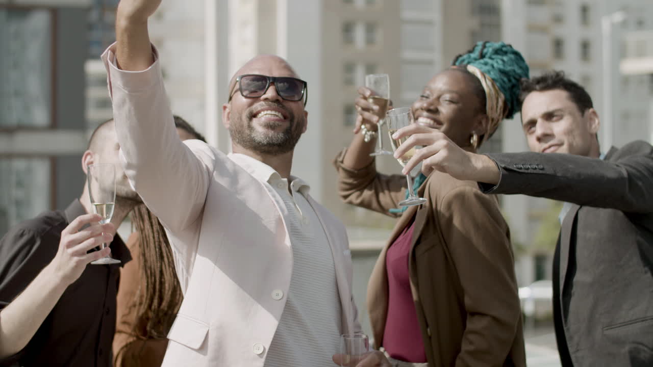 Front view of executive taking selfie with colleagues at party