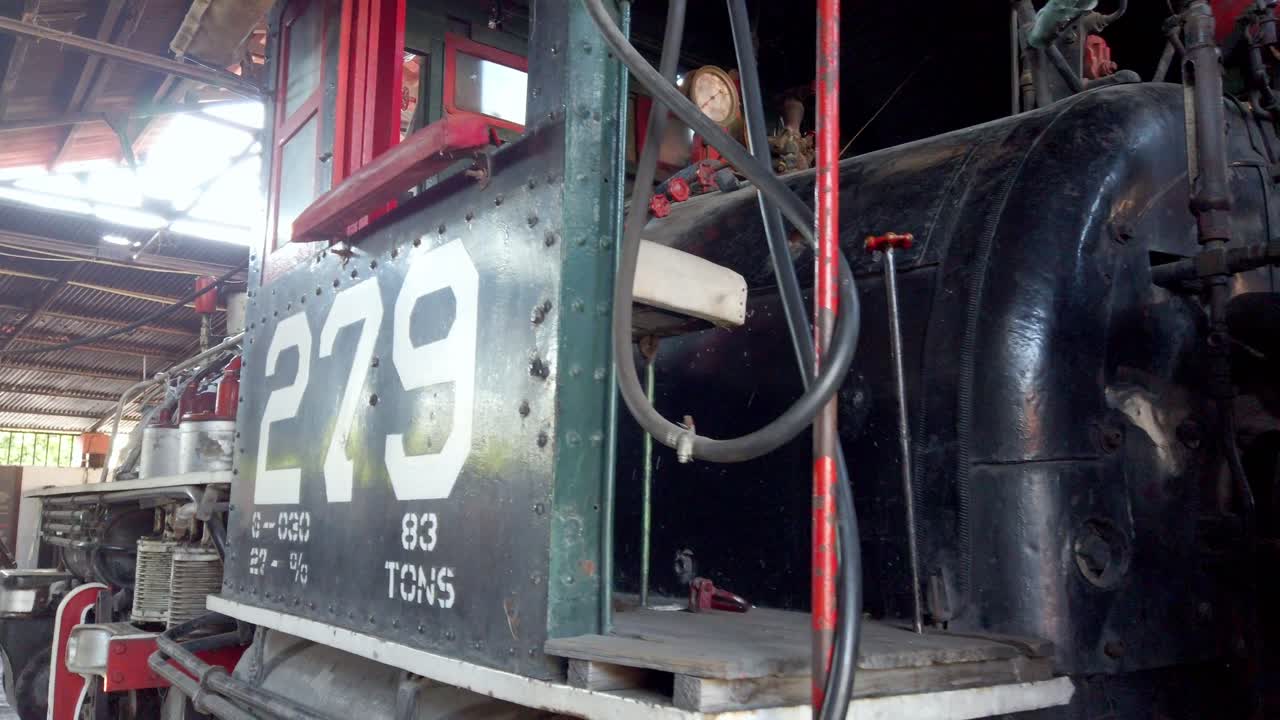 Old steam train in a rustic shed, number 279 visible on side