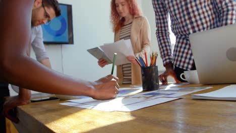 Low-angle-view-of-young-mixed-race-business-team-working-in-meeting-room-of-modern-office-4k