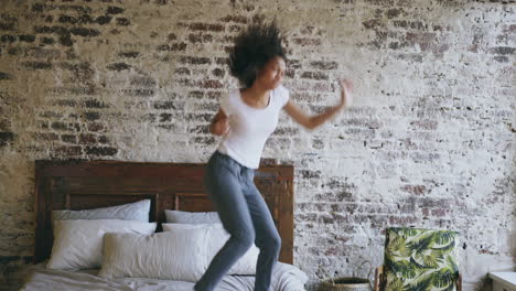 happy woman jumping on bed