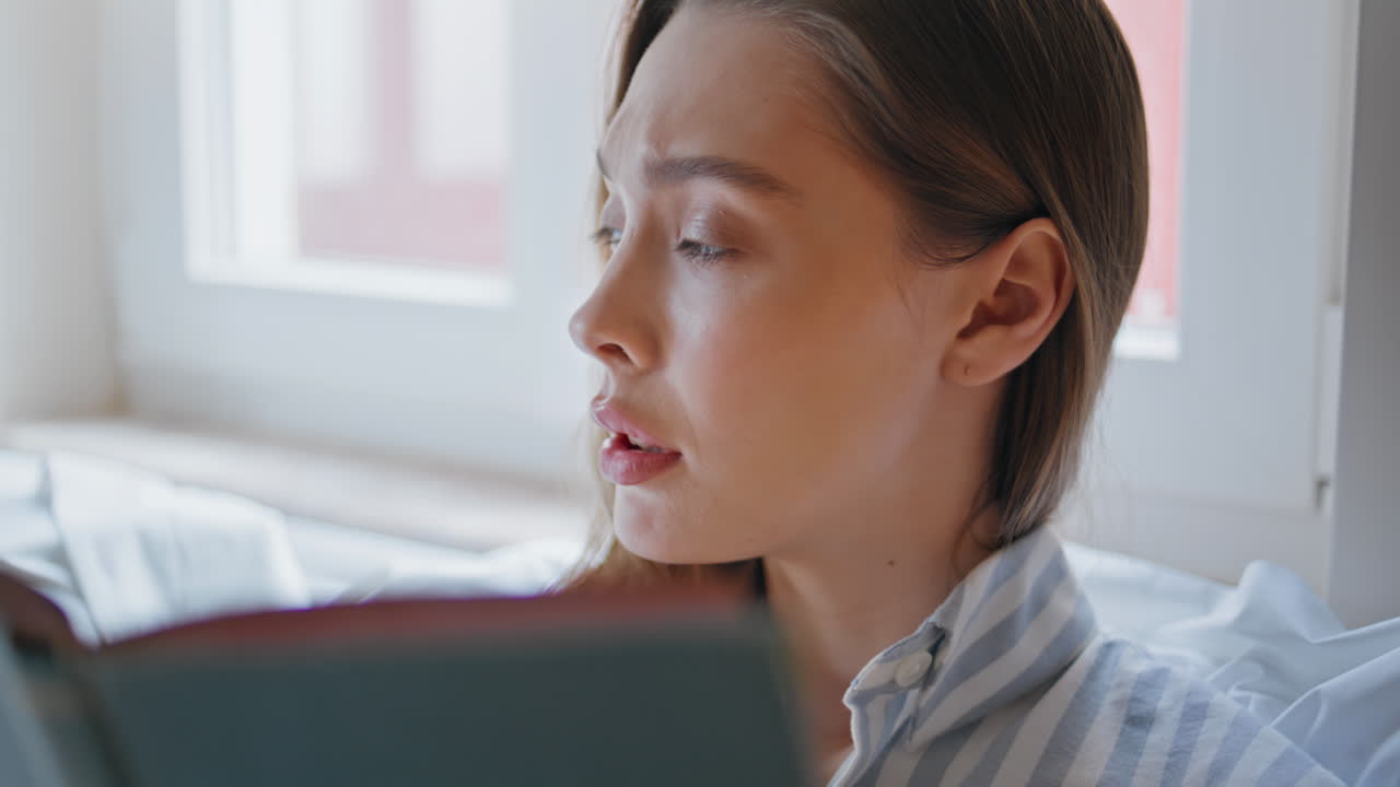 Pensive woman thinking book at modern bedroom closeup. Focused intellectual lady