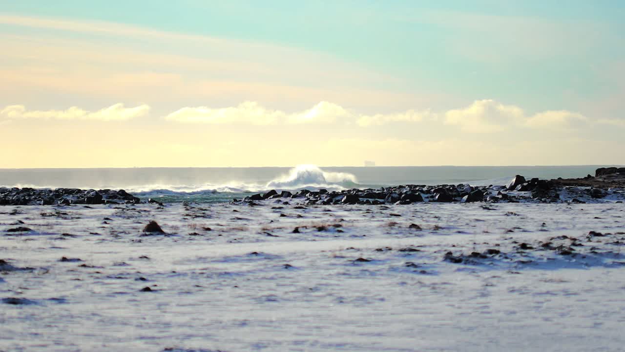 밝은 날 겨울에 아이슬란드에서 큰 파도가 멀리 부서지는 슬로우 모션 샷