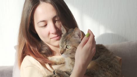 woman kissing her cute cat.