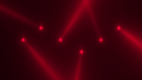glowing red spotlight beams on stage