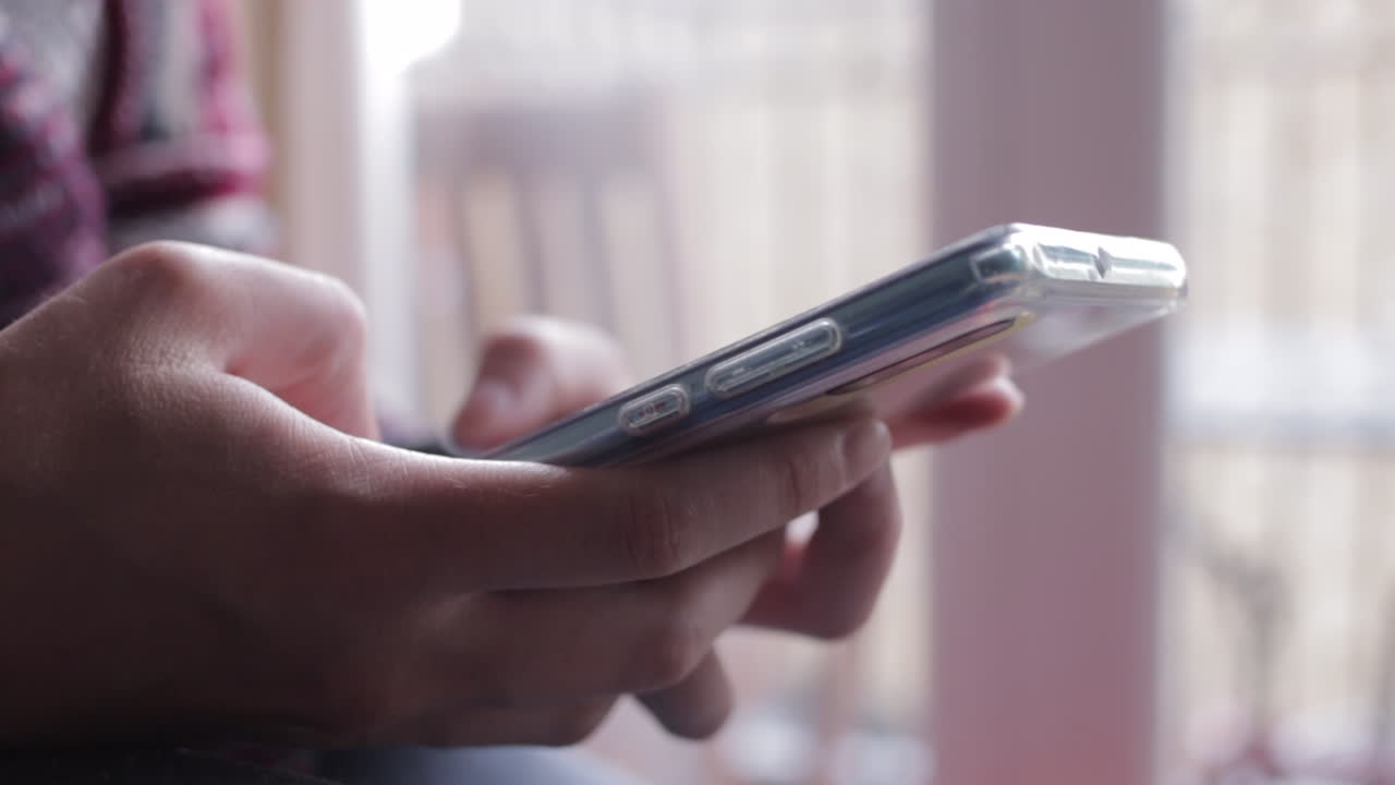 Close up of woman's hands texting or scrolling on phone