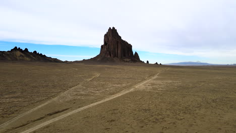 Dirt-Road-In-The-Desert-With-Panorama-Of-Shiprock-In-New-Mexico