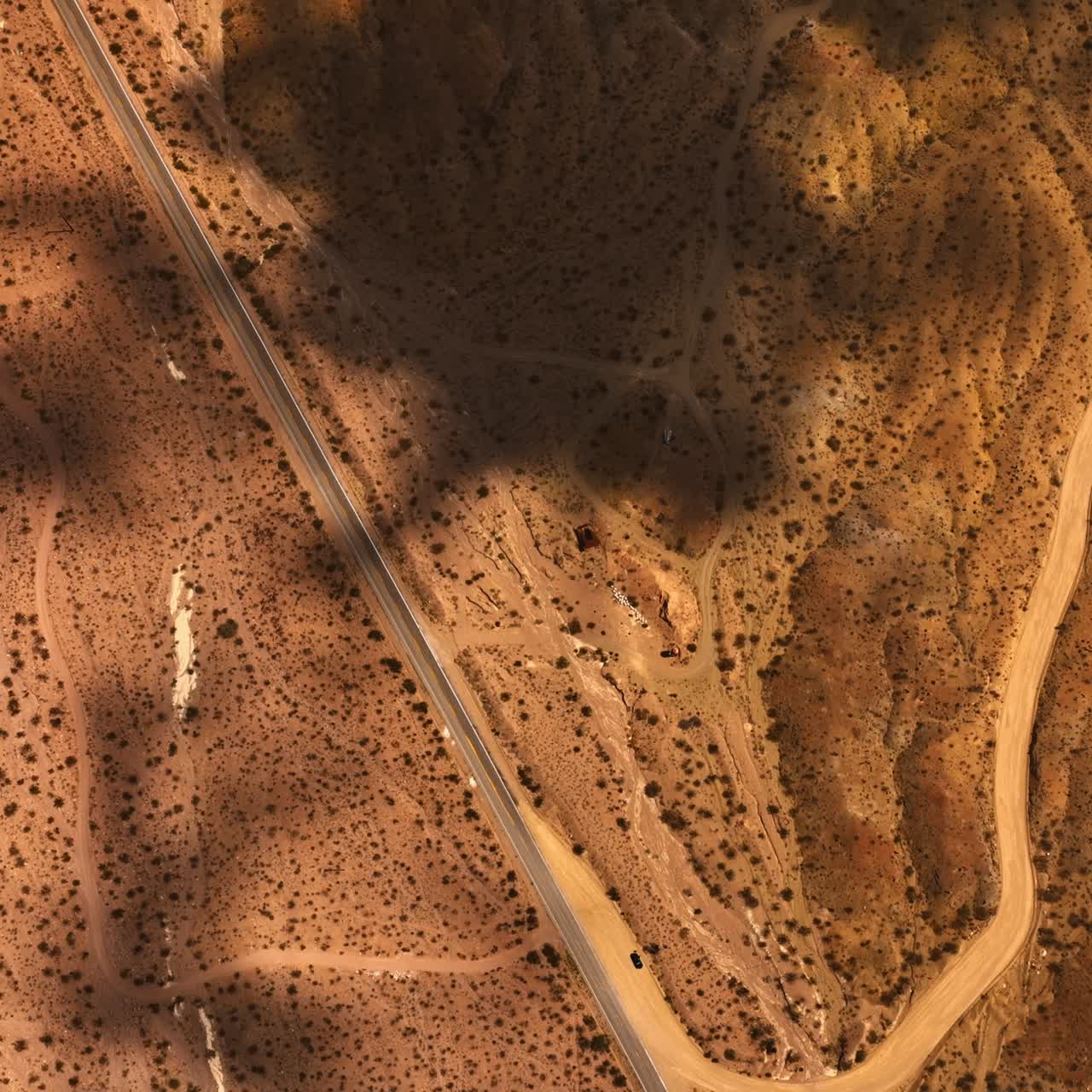 Dry hot area of Mojave desert, California, USA. Shadows of clouds floating by the landscape. Top view