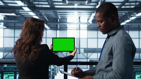 data center colleagues using green screen chroma key device to monitor facility