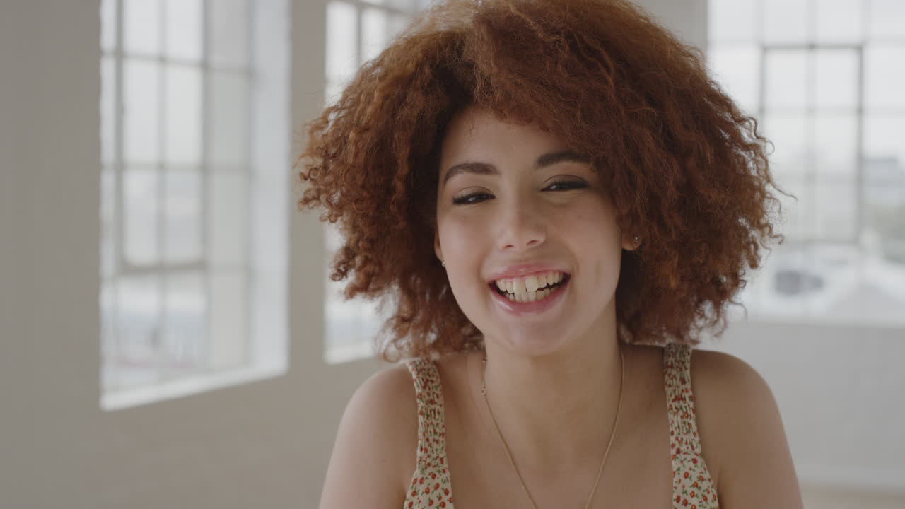 retrato de una joven animada de raza mixta sonriendo alegremente disfrutando de un estilo de vida feliz e independiente estudiante excitada en un nuevo apartamento