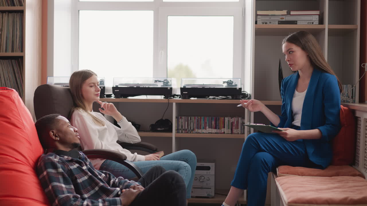 Psychologist guides therapy session for married couple. Young female therapist explains family widespread problems in communication. Healthy relationships