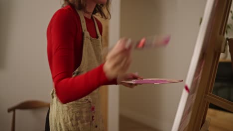 woman painting on easel