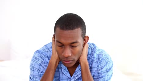 Hungover-man-touching-his-on-the-end-of-his-bed