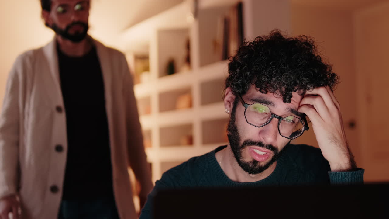 Gay Couple Working From Home on Laptop