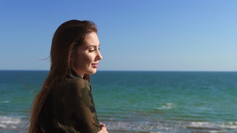 Woman-with-long-hair-enjoying-the-sea-view-outside.-Slowmotion-shot