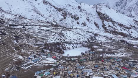snowy mountain village and frozen lake