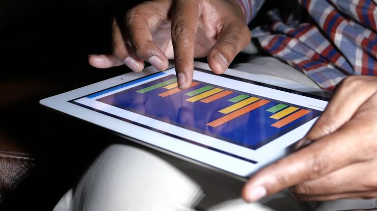 Person using a tablet with a bar graph
