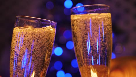 people clink glasses of champagne and celebrate the new year 2021