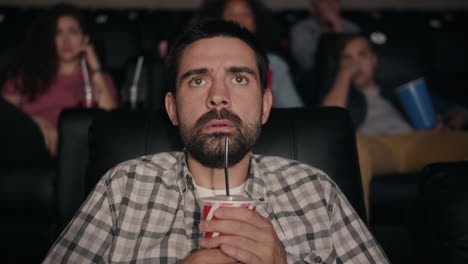 man watching a movie in a cinema