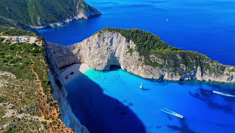 Famous-greek-beach-with-shipwreck-on-a-beautiful-bright-summer-day,-aerial