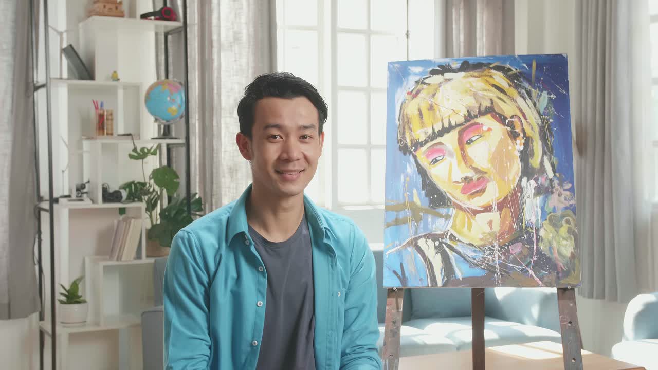Asian Artist Man Holding Paintbrush Mixed Colour Wipe The Sweat Before Crossing His Arms And Smiling After Finish Painting A Girl On The Canvas