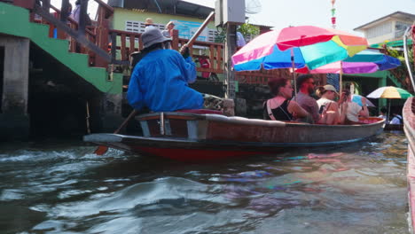 a boat ride through the floating market in thailand