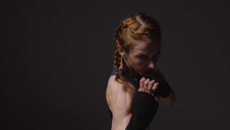 Studio-Portrait-Of-Mature-Woman-Wearing-Gym-Fitness-Clothing-Exercising-Sparring-At-Camera-5