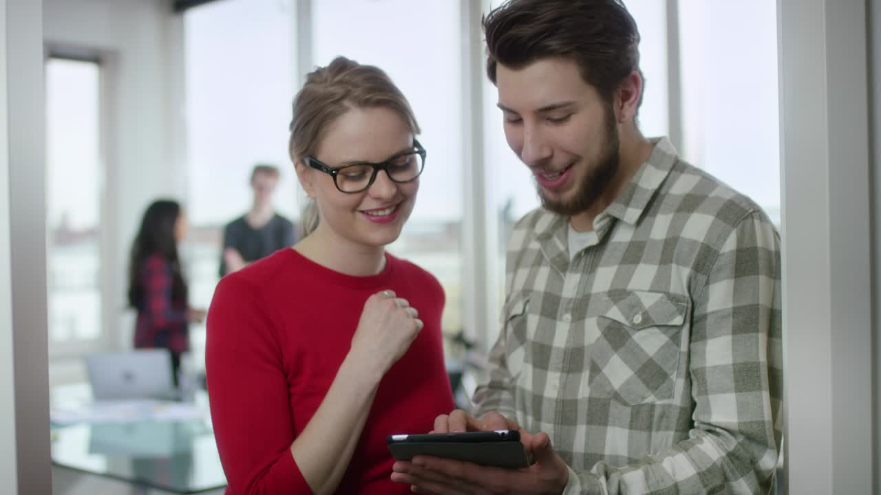 Business Colleagues looking at Smartboard in Office
