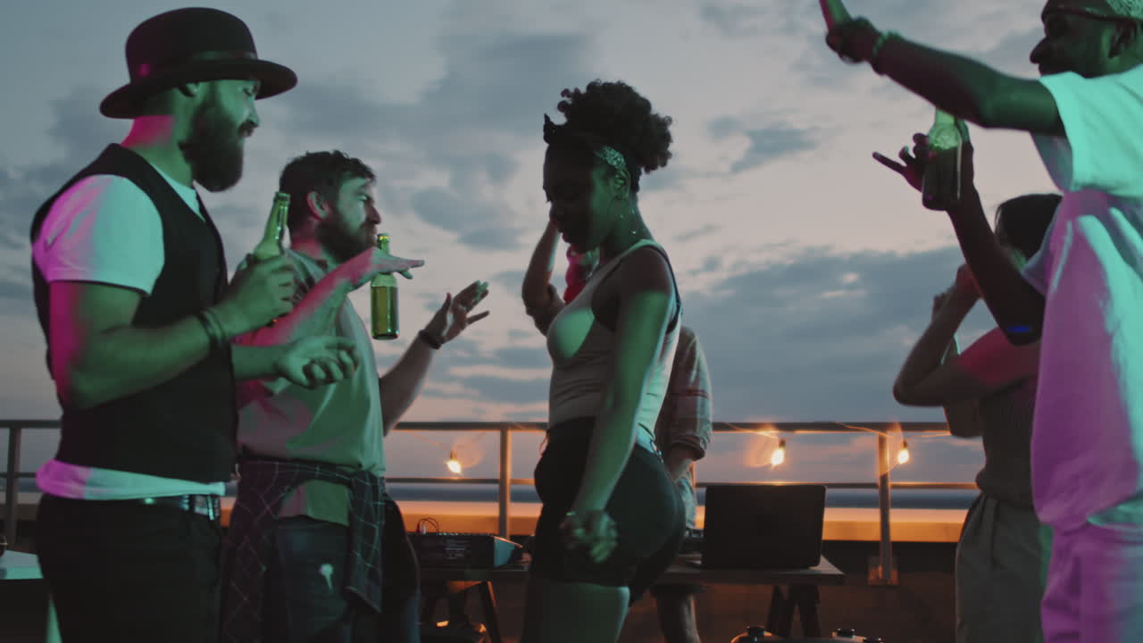 Group of People Partying on Rooftop in Evening