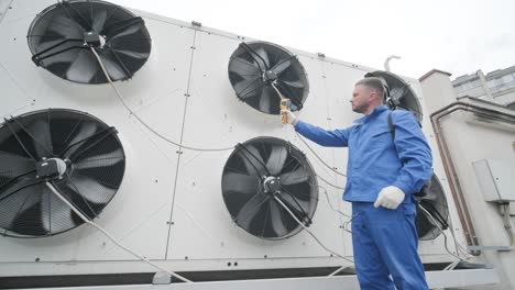 technician uses a thermal imaging infrared thermometer to check the condensing unit heat exchanger