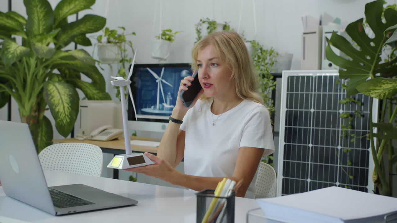 Female Manager Calling Client to Confirm Wind Power Project Details