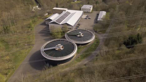 two round pools of a drinking water treatment plant behind several power lines