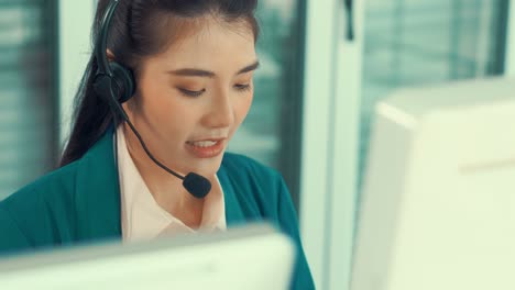 businesswoman wearing headset working actively in office