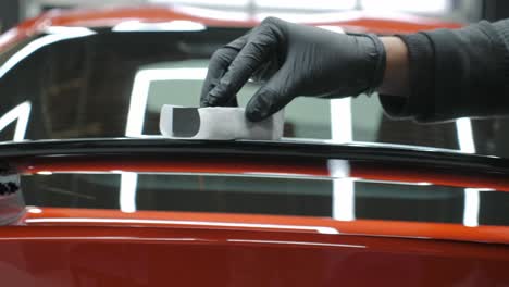 Hand-Applying-Ceramic-Coating-To-Car-Spoiler-With-Foam-Block-Applicator