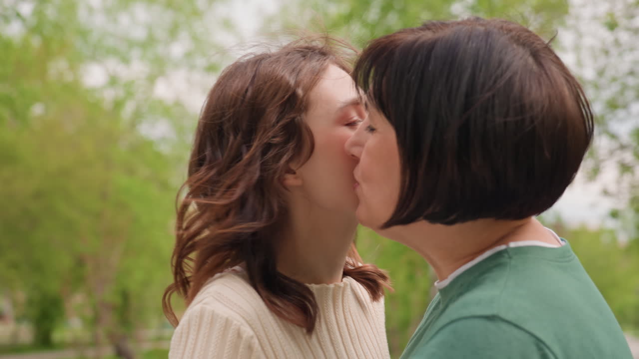 Joyful Reunion Embrace, Candid Moment Of Friends Reconnecting With Warmth And Joy Outdoors, Unexpected Joyful Surprise Leads To Affectionate Embraces Among Friends In Natural Park Setting