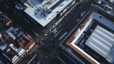 Flying-above-main-intersection-in-Nitra-City-Centre-near-shopping-centre-and-marketplace-Winter,-Top-down-Aerial-shot,-Slovakia