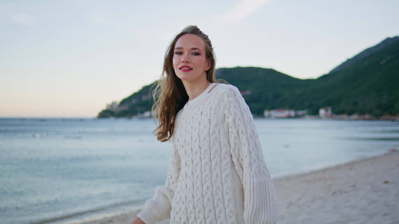 Happy brunette enjoying beach nature at evening closeup. Attractive model posing